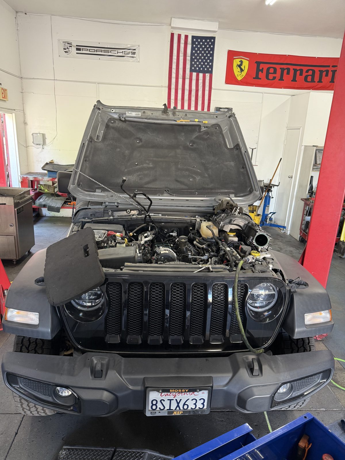 Jeep with the front end opened up for repair